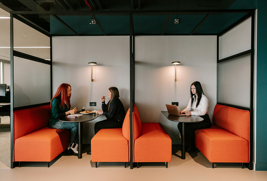 lounge work space with people working and conversing
